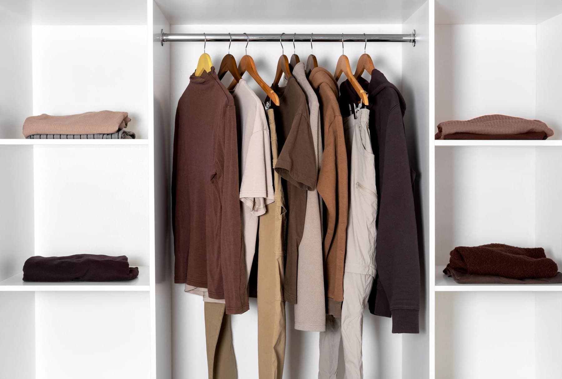Organized walk-in closet with color-coordinated clothing